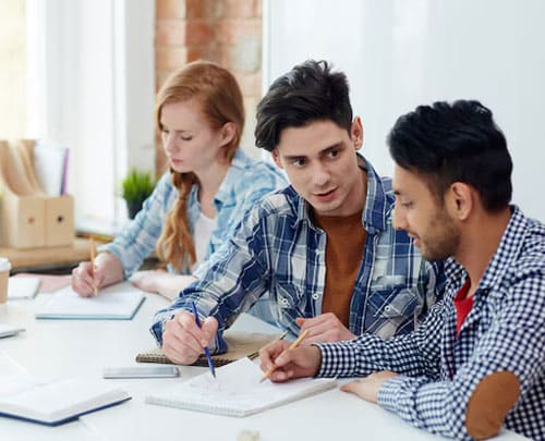 students brainstorming with one another