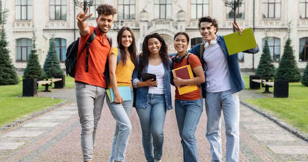 a bunch of students taking a selfie at the university campus